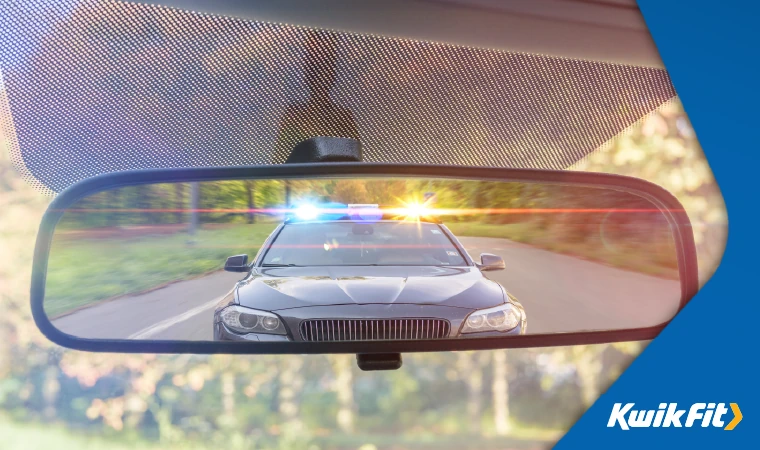 Police and flashing lights behind a car